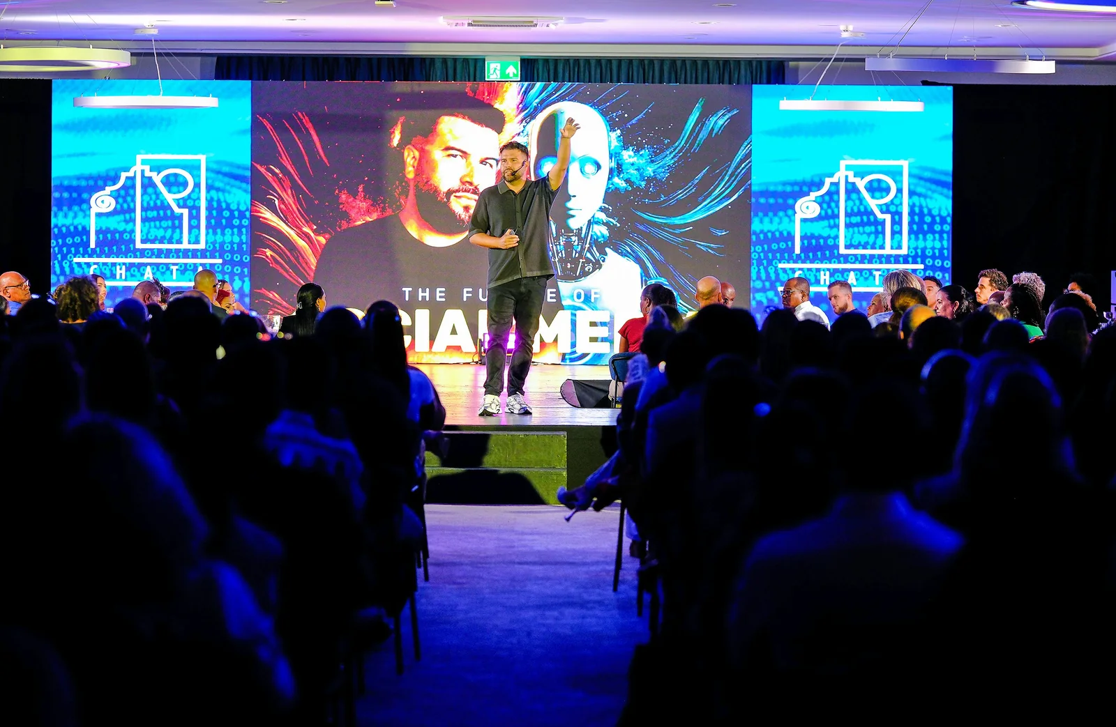 A conference speaker presenting to a live audience